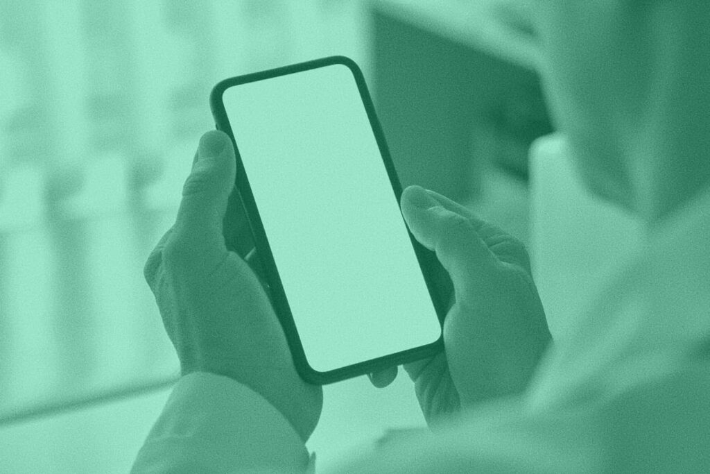 An individual looks at a mobile device screen