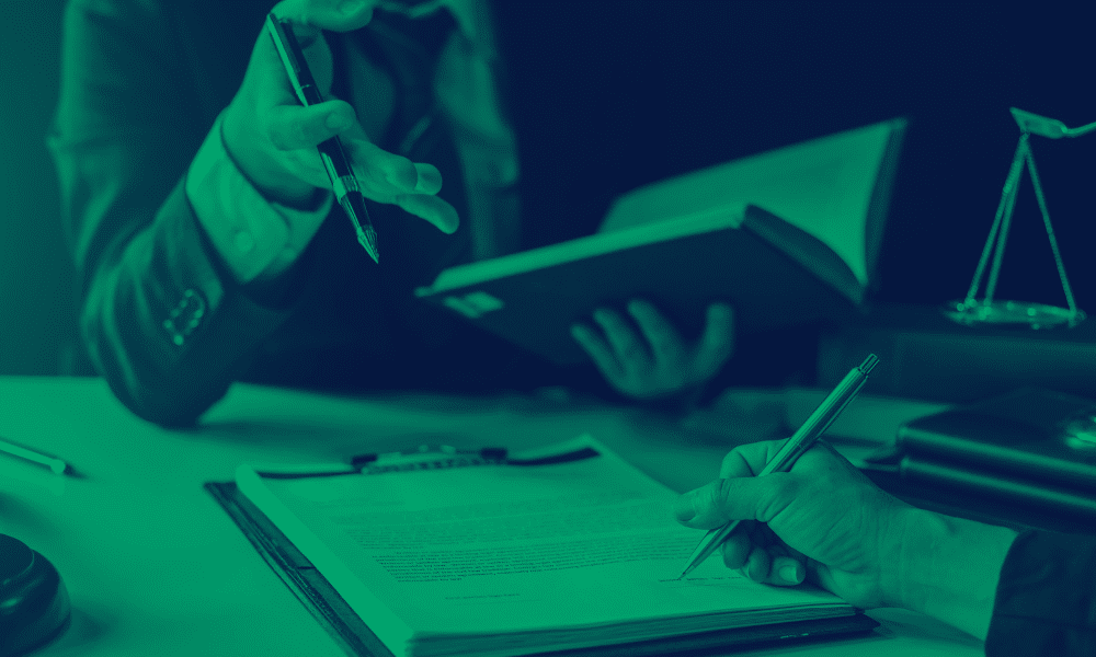 Photo of two people working on legal documents